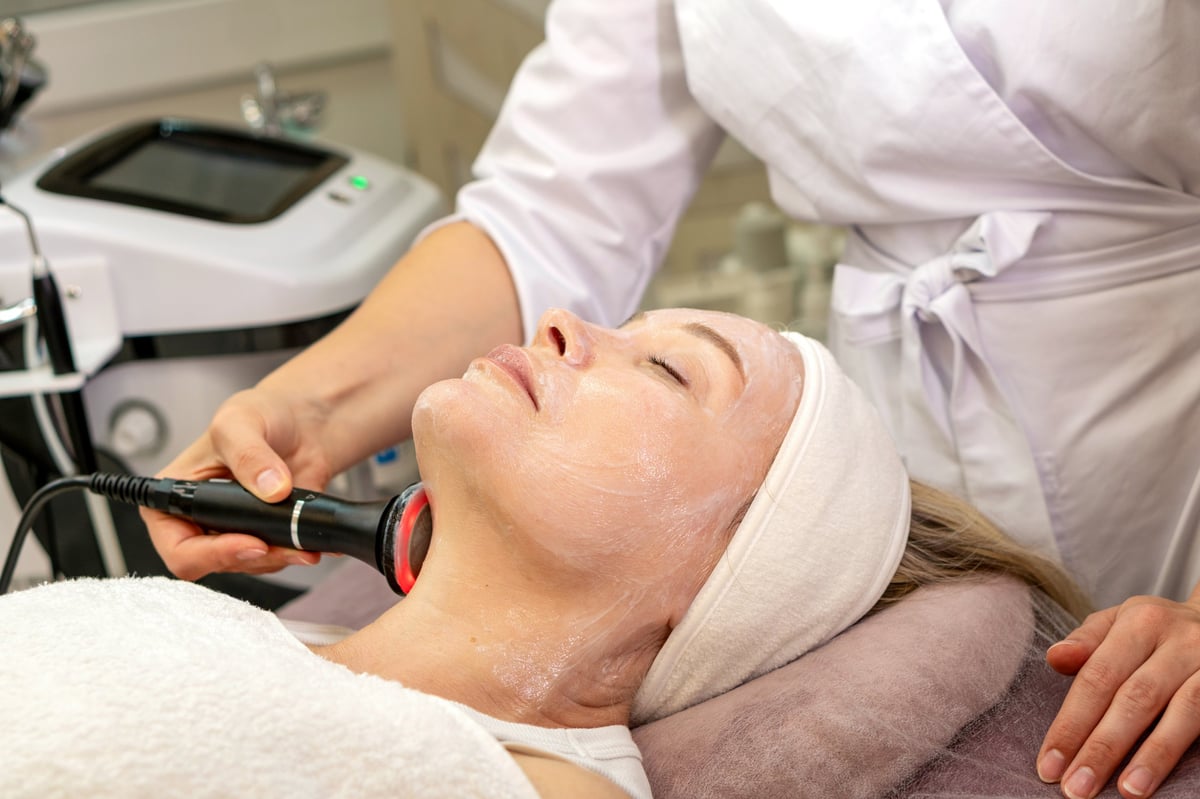 Professional radio frequency treatment performed along jawline and neck to improve skin firmness and facial definition.